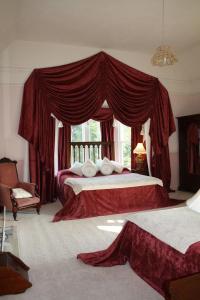 a bedroom with a large bed with a canopy at Maranatha Country House in Blarney