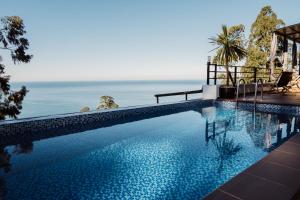 a swimming pool with a view of the ocean at VILLA EVKALIPT Kvariati in Kvariati