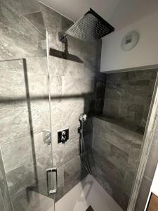 a shower with a glass door in a bathroom at T3 neuf Courchevel 1650 Domaine de l’Ariondaz in Courchevel