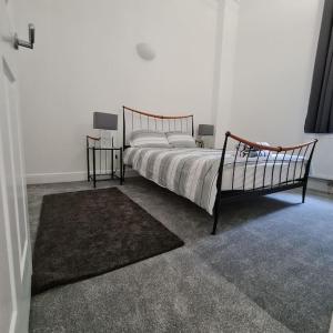 a bedroom with a bed and two night stands at Regent Apartments - Glasgow City Centre in Glasgow