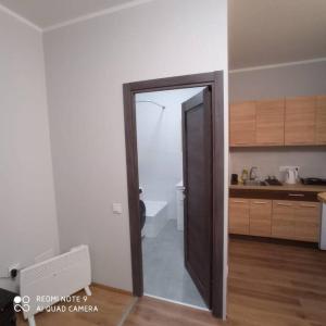 a room with a door open to a kitchen at Simana 3A Ideal for family and older pers in Rīga