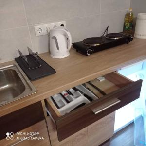 a kitchen counter with a sink and a microwave at Ideal for family and older pers. in Rīga