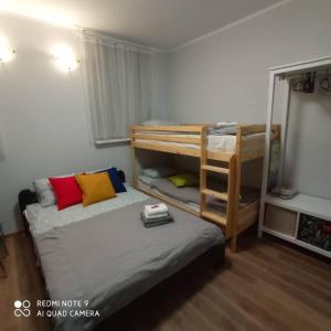 a bedroom with a bunk bed and a bunk bed with a ladder at Ideal for family and older pers. in Rīga