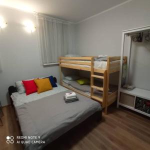 a bedroom with a bunk bed and a bunk bed with a ladder at Simana 3A Ideal for family and older pers in Rīga