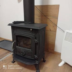 an old black stove sitting in a room at Simana 3A Ideal for family and older pers in Rīga