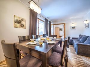 a dining room with a table and a couch at VisitZakopane - Lemon Apartment in Zakopane +30 photos