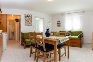 a kitchen and living room with a table and chairs at Central Little Home in Kalabaka