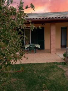 a house with a bench on a patio at Agriturismo dal Pastore in Follonica