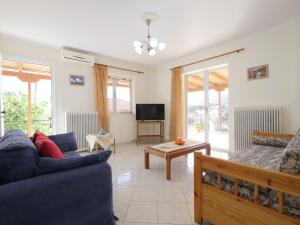 a living room with a couch and a tv at GM country house in Porto Rafti