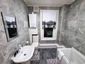 a bathroom with a sink and a toilet and a tub at *6R* setup for your most amazing & relaxed stay + Free Parking + Free Fast WiFi * in Beeston Hill