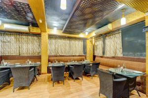 a restaurant with tables and chairs in a room at Itsy By Treebo - Buddha Inn in Patna