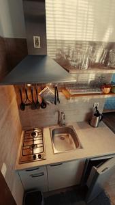 a small kitchen with a sink and a stove at DREVENÝ APARTMÁN Slovenský raj Hrabušice in Hrabušice +13 photos