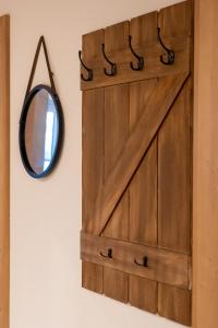 a wooden door with a mirror on a wall at Haus Stangl in Bad Aussee