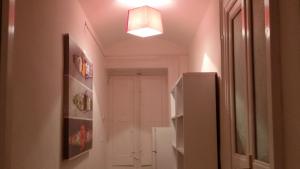 a hallway with a white refrigerator and a light at Portobello Appartamento 3 camere 3 bagni in Taranto