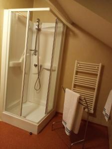 a bathroom with a shower and a towel at Auberge du Marronnier in Belmont-sur-Rance