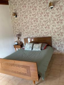 a bed with two pillows on it in a bedroom at A Casetta d’Hélène et Jeanette in Omessa +10 photos