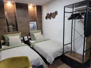 a bedroom with two beds and a mirror at Chalupa Oslany in Oslany