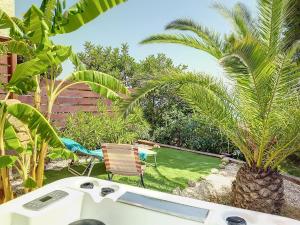 a boat in a garden with a palm tree at Casa Altea Hills, Vista panorámica, Jacuzzi in Altea