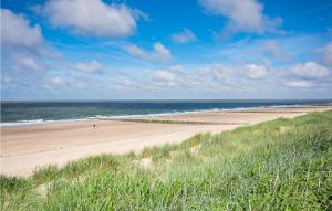 a beach with people on the sand and the ocean at 1 Bedroom Gorgeous Home In Vlissingen in Vlissingen