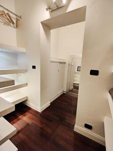 an empty room with white walls and wood floors at Designed Pop Apartment 2 Bedrooms, 2 Baths in Milan Center - WiFi, AC, steps from Subway M1 and M2, Central Station and Airport connected in Milan