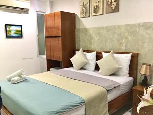 a hotel room with two beds at SaiGon CoZy Hotel "241 Pham Ngu Lao Street'' in Ho Chi Minh City
