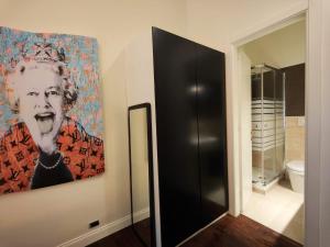 a painting of a man on a wall next to a bathroom at Designed Pop Apartment 2 Bedrooms, 2 Baths in Milan Center - WiFi, AC, steps from Subway M1 and M2, Central Station and Airport connected in Milan +10 photos