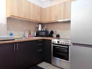 A kitchen or kitchenette at Koukaki cozy apartment 5 minutes to metro