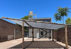 an old brick building with a covering in front of it at Departamento Hilario in San Rafael