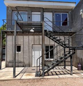 un edificio con una escalera de caracol frente a un edificio en Departamento Hilario en San Rafael