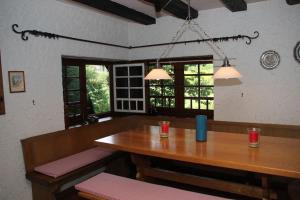 a dining room with a wooden table and chairs at Black Forest House in Wolfach