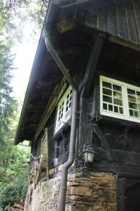 a building with two windows and a pipe at Black Forest House in Wolfach