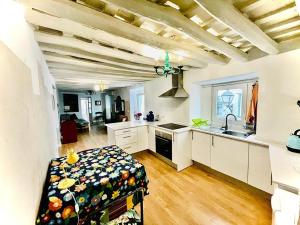 a large kitchen with white cabinets and a sink at Apartamentos La Selva in Cádiz