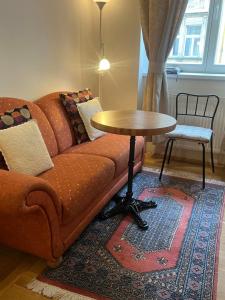 a living room with a couch and a table at Apartments Emma in Prague +9 photos