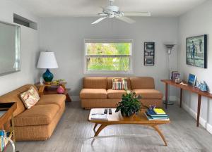 a living room with two couches and a table at South Beach Place - Vero Beach in Vero Beach