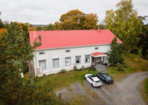 an aerial view of a white house with a red roof at Cozy Studio - 7 min to Tampere Airport - Free Parking in Pirkkala