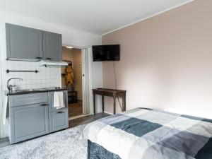 a kitchen with a bed and a sink in a room at Cozy Studio - 7 min to Tampere Airport - Free Parking in Pirkkala +11 photos