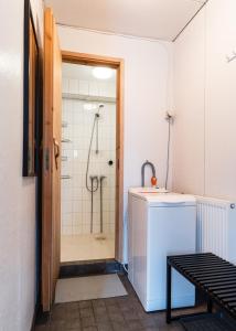 a bathroom with a shower and a washing machine at Cozy Studio - 7 min to Tampere Airport - Free Parking in Pirkkala