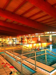 a large swimming pool with people in it at Karolina Apartment in Békéscsaba