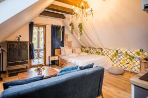 a living room with a bed and a couch at Hanul Anei Studios and Apartments Brasov Transylvania in Braşov