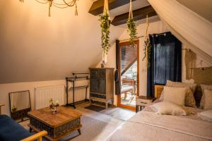 a bedroom with a bed and a table at Hanul Anei in Braşov