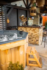 a hot tub in the middle of a patio at Hanul Anei in Braşov