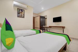 a hotel room with two beds and a television at Treebo Trend Virat Residency - US Consulate in Hyderabad