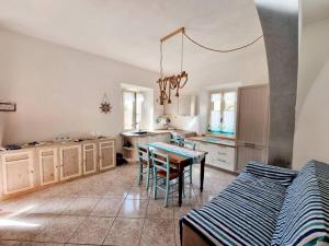 a kitchen with a table and a dining room at Mojito's house in Rio Marina