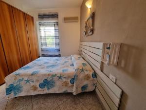 a bedroom with a bed with a comforter on it at Mojito's house in Rio Marina