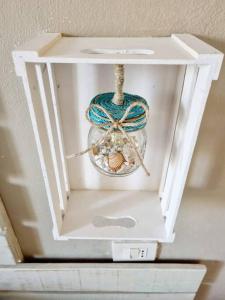 a white box with a ball of yarn and a rope at Mojito's house in Rio Marina +3 photos
