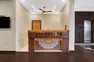 a reception desk in a room with a sign on it at Treebo Trend Virat Residency - US Consulate in Hyderabad