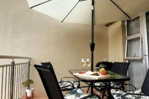 a dining room with a table with chairs and an umbrella at I 6 Goose Valley! Golf and more in Plettenberg Bay