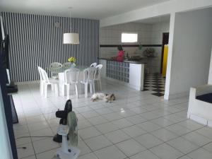 a cat laying on the floor in a kitchen at Casa Beira Mar Serrambi in Porto De Galinhas