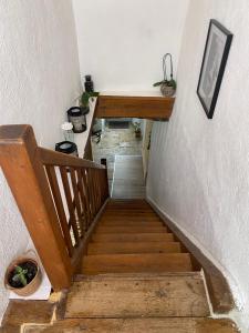 a stairway with a wooden railing and a stair case at La Maison du Commandeur in Maine-de-Boixe +9 photos