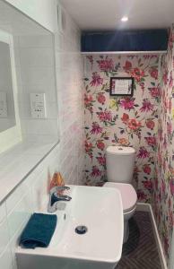 a bathroom with a white sink and a toilet at The Pigsty in Braunton in Braunton